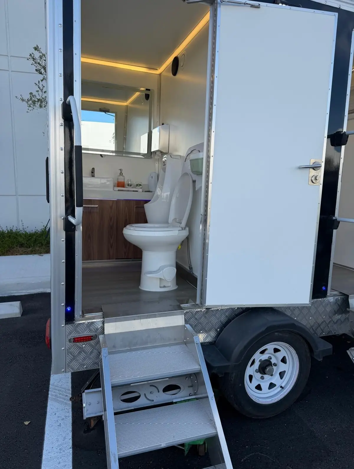 Steps leading up to the door of a luxury restroom trailer