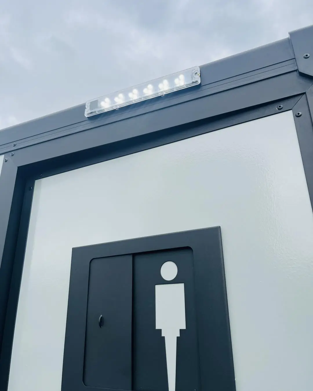 Men's restroom sign on the door of a restroom trailer