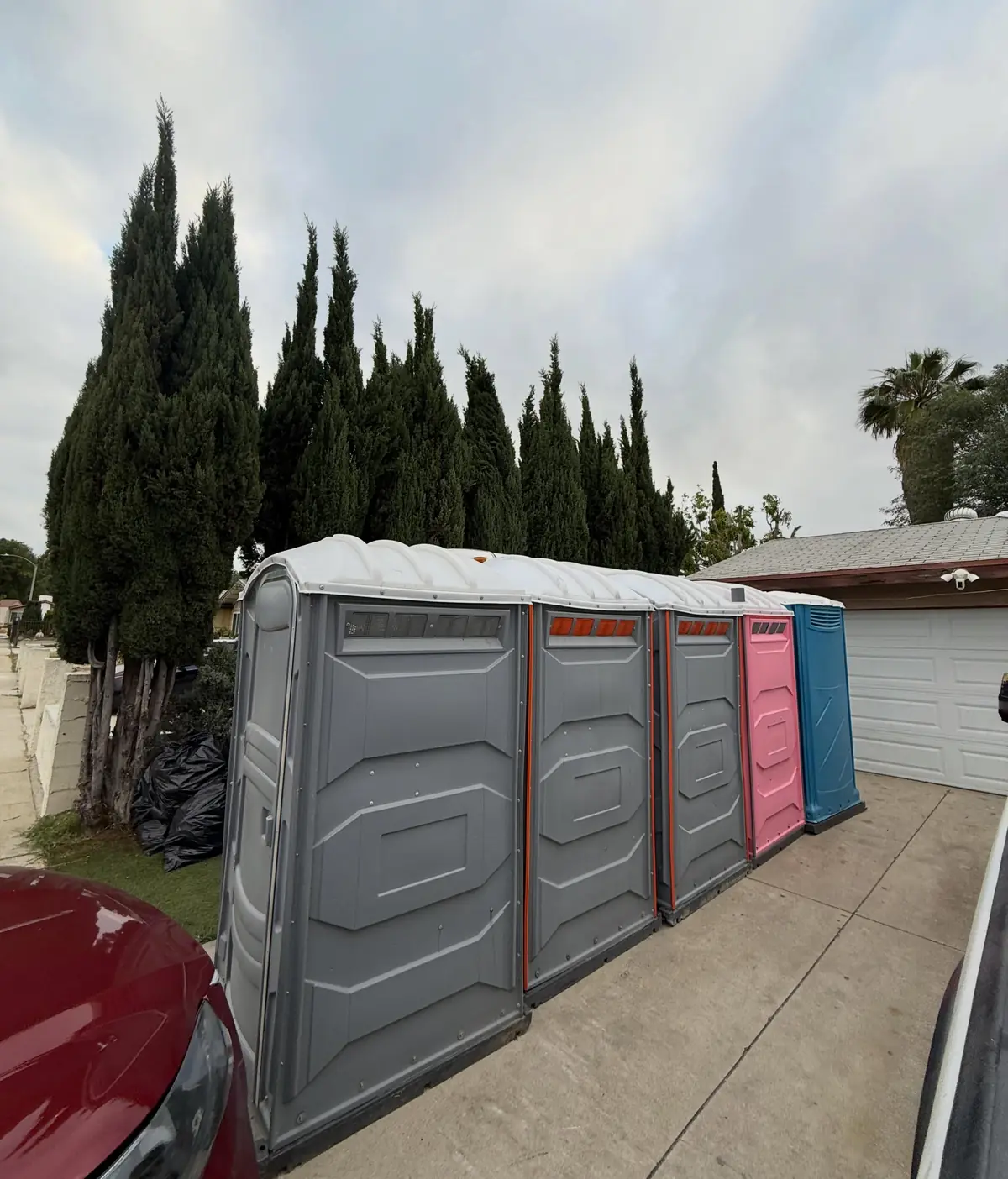 Row of porta potties along a curb
